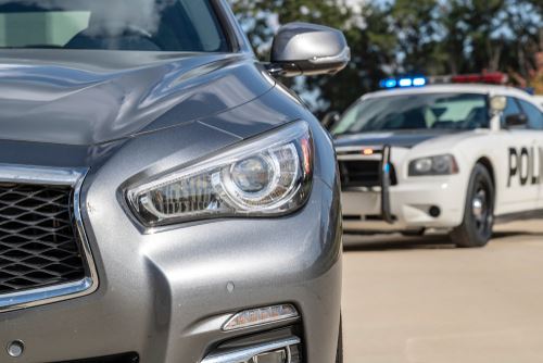 Police car behind driver driving under the influence